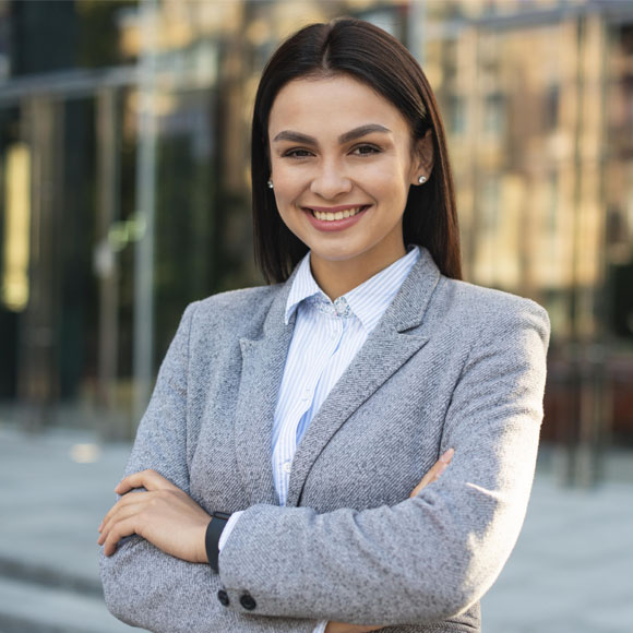 Professional woman smiling confidently outside a city office building